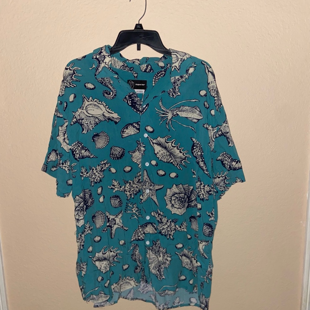 blue and white shell print short sleeve button up shirt collared graphic tee